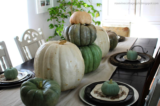 Neutral Fall Dining Room Decor | green blue and white pumpkins on a black table set for dinner | rosevinecottagegirls.com