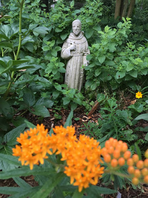St Francis statue with flowers in Bed and Breakfast garden