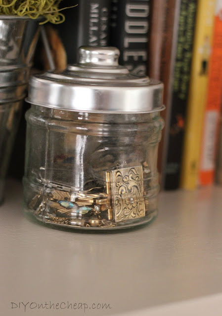 Display heirloom or vintage costume jewelry in small decorative jars.