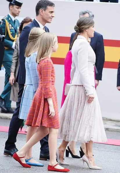 Queen Letizia wore Felipe Varela coat and dress. Crown Princess Leonor and Infanta Sofia attended National Day 2018 parade held at Plaza de Lima