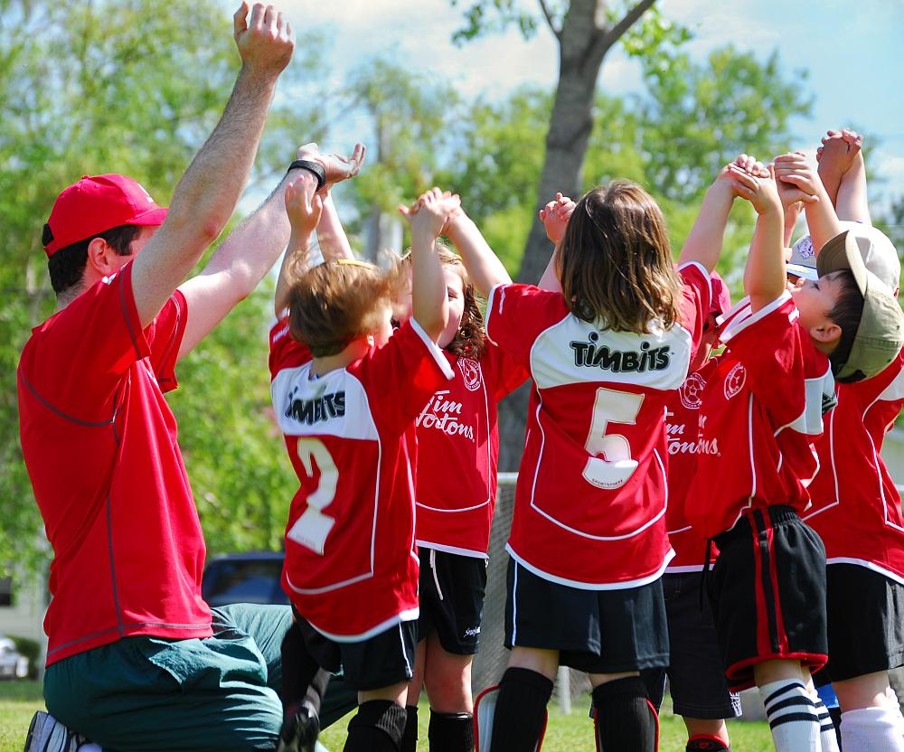 Children's soccer team cheering.