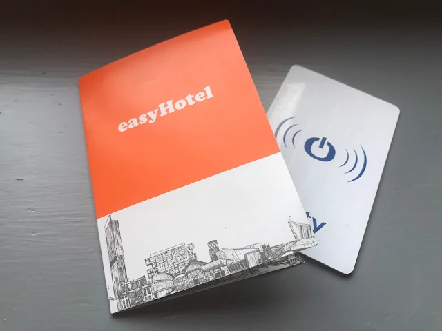 A hotel key card and a piece of cardboard with easyHotel on it