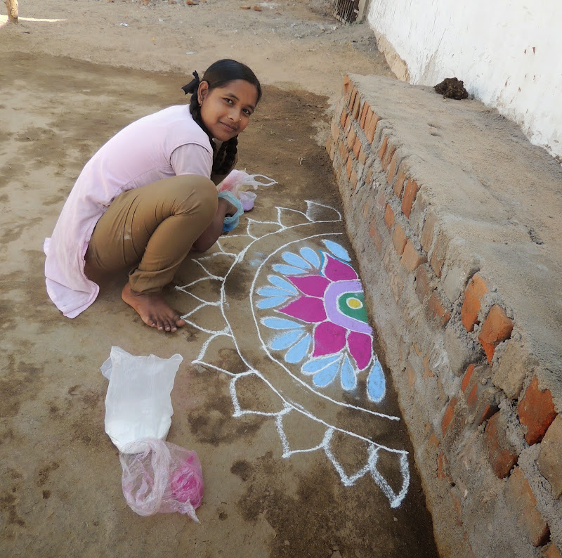 Faces in the Crowd the girl drawing a rangoli