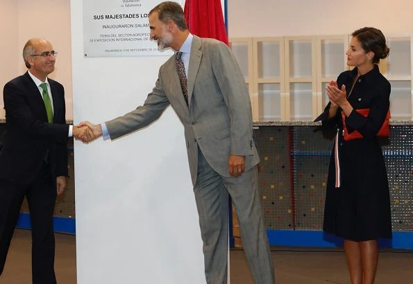 Queen Letizia wore HUGO BOSS Caddli Stretch Denim Dress, Carolina Herrera pumps, Angel Schlesser Clutch Bag