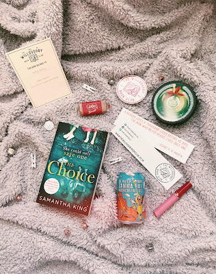 flatlay image of a book surrounded by items such as beer and lipgloss