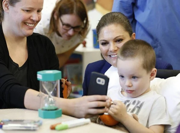 Crown Princess Victoria's Children and Youth Hospital. Erdem x H&M floral blouse Af Klingberg boots, Valentino shoulder bag