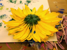 place flower head on paper and press down on all petals