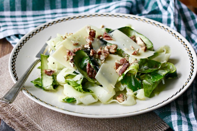 This Zucchini Parmesan Salad is an wonderful combination of raw zucchini topped with shaved Parmesan and candied pecans, and dressed with a bright lemon dressing.