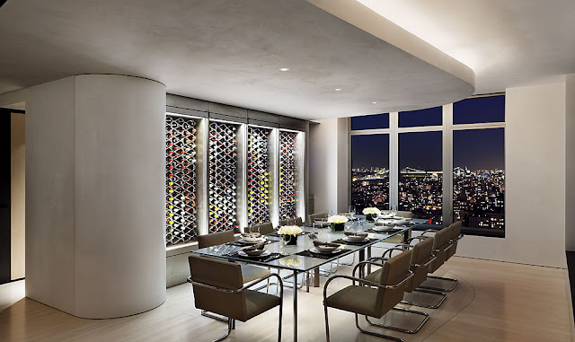 Photo of modern dinning room at night with wine wall 