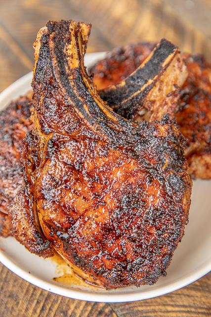 The Ultimate Pork Chops - so tender and juicy. You can cut them with a butter knife!!! Pork chops brined overnight in water, sugar and salt. Rub in a mixture of paprika, garlic powder, onion powder, cumin, dry mustard, pepper and chili powder. Seriously THE BEST!!! Everyone RAVES about these delicious grilled pork chops! #grill #grilling #pork #porkchops The Ultimate Pork Chops - so tender and juicy. You can cut them with a butter knife!!! Pork chops brined overnight in water, sugar and salt. Rub in a mixture of paprika, garlic powder, onion powder, cumin, dry mustard, pepper and chili powder. Seriously THE BEST!!! Everyone RAVES about these delicious grilled pork chops! #grill #grilling #pork #porkchops