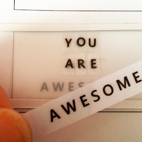 Words 'You are awesome' printed out and being attached to a miniature light box front.