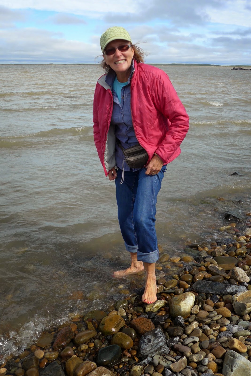 Liz dipping her feet in the Arctic Ocean.