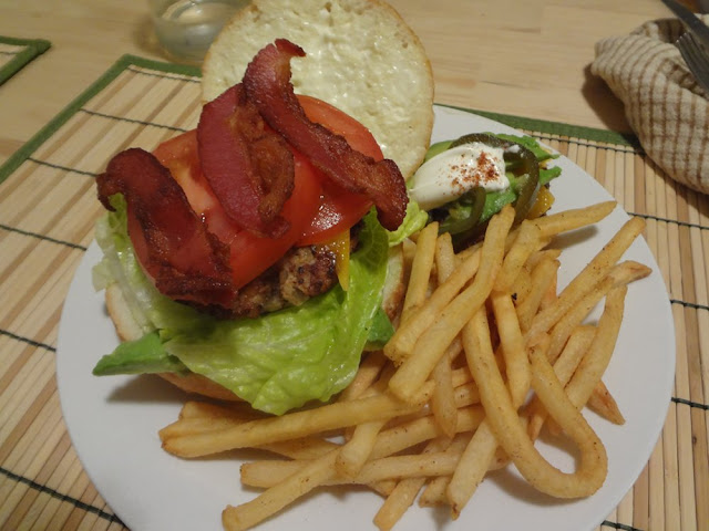turkey burger with bacon, lettuce, tomato, cheese, avocado, french fries, sour cream, jalapenos