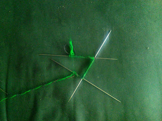 Two-colour Double-Knitting cast on to three double-pointed needles. 
