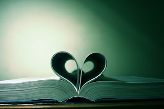 open book with center pages bent to form a heart in the middle