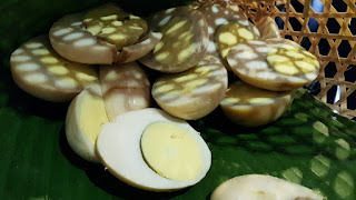 These are telur pindang, eggs boiled with soy sauce and other colouring agents. 