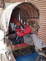 Sleeping three-wheeled bicycle taxi driver - Kathmandu