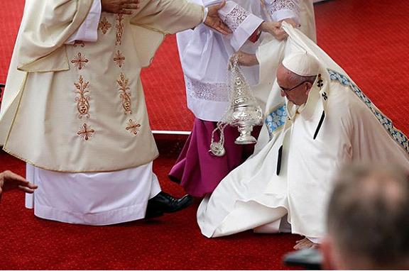 Pope Francis misses a step and falls down during mass