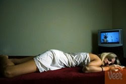 Woman asleep in front of TV