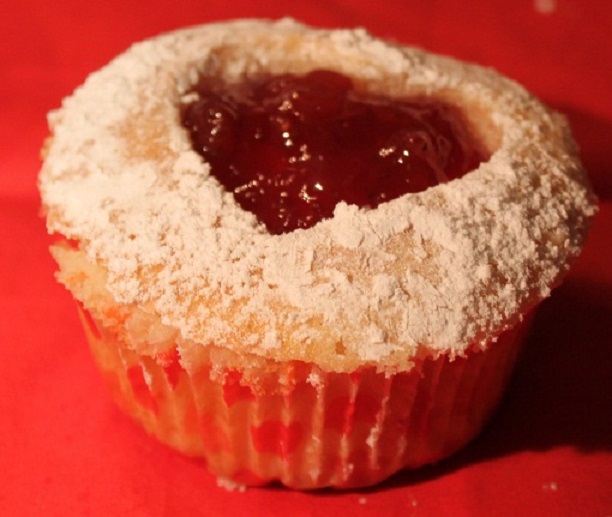 this is a homemade heart shaped cake filled with Red Raspberry Jam and coconut then sprinkled with powdered sugar for Valentines Day