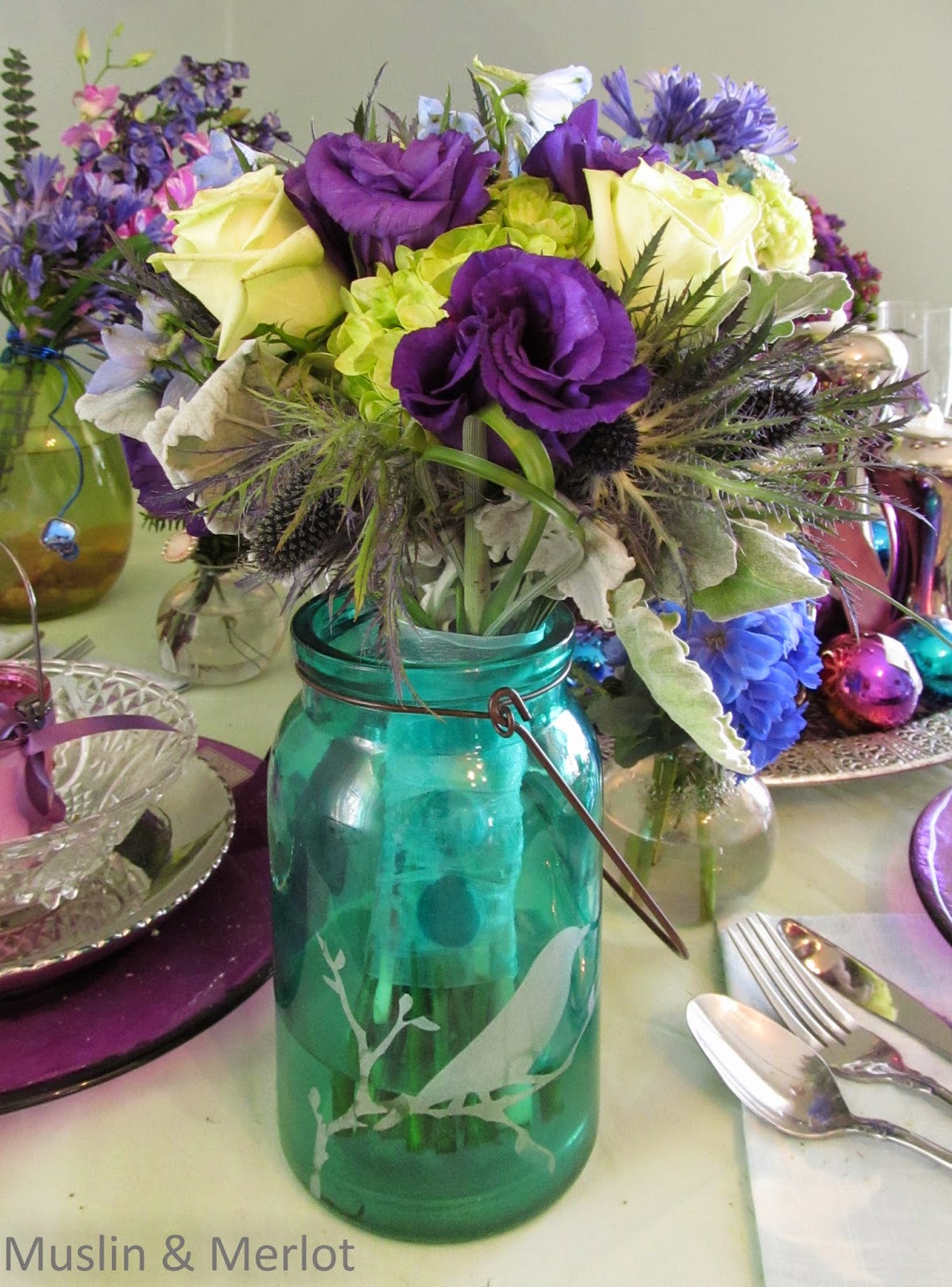 Stems wrapped in ribbon, placed in painted jar. Very pretty.