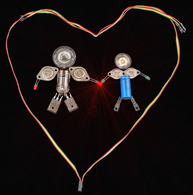 Elektryzujące uczucie - dziewczyna i chłopak z części elektronicznych w sercu z kolorowych przewodów