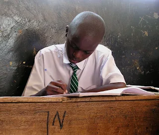 Reading his school book in Tanzania Africa