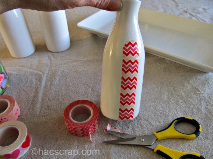 adhereing washi tape to milk bottle