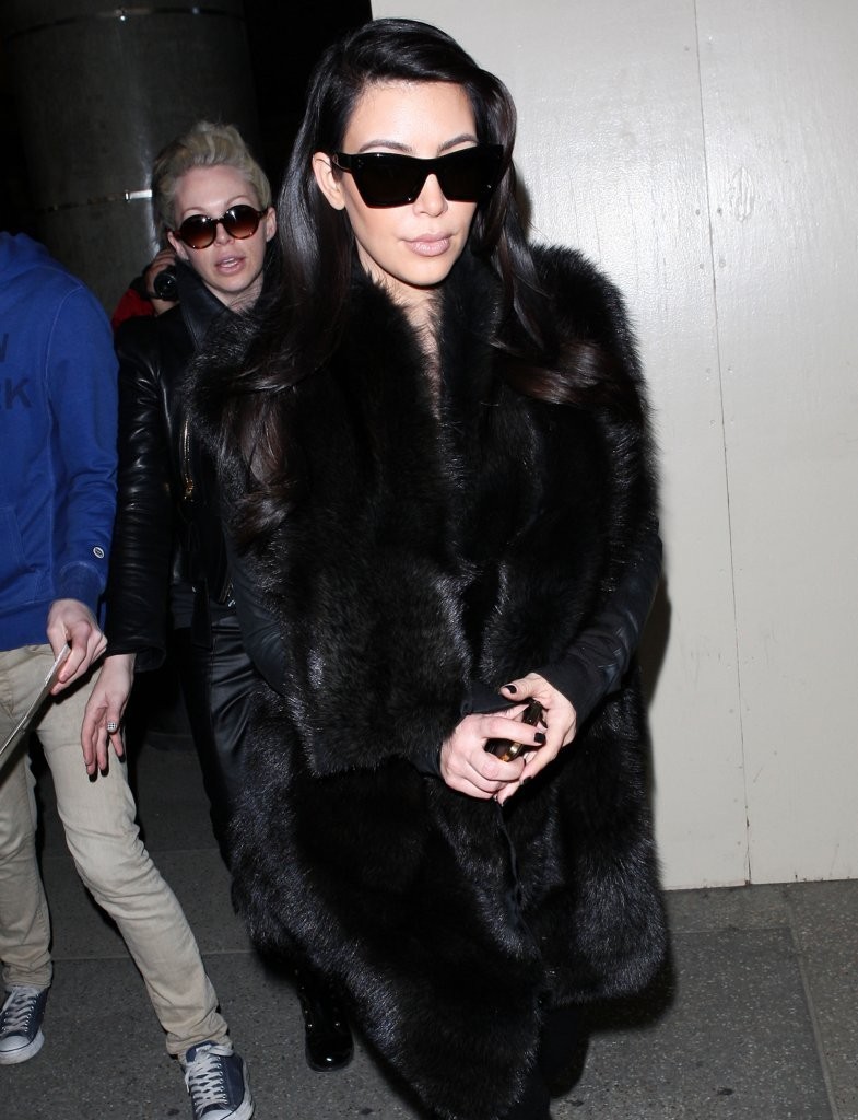 Hollywood Celebrities: Kim Kardashian arrives at LAX wearing a fur coat.