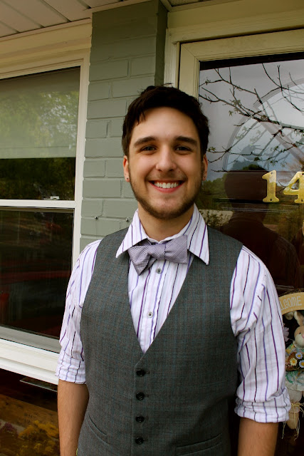 A man wearing a suit and tie smiling at the camera