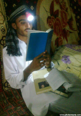 funny student reading book with headlight cap