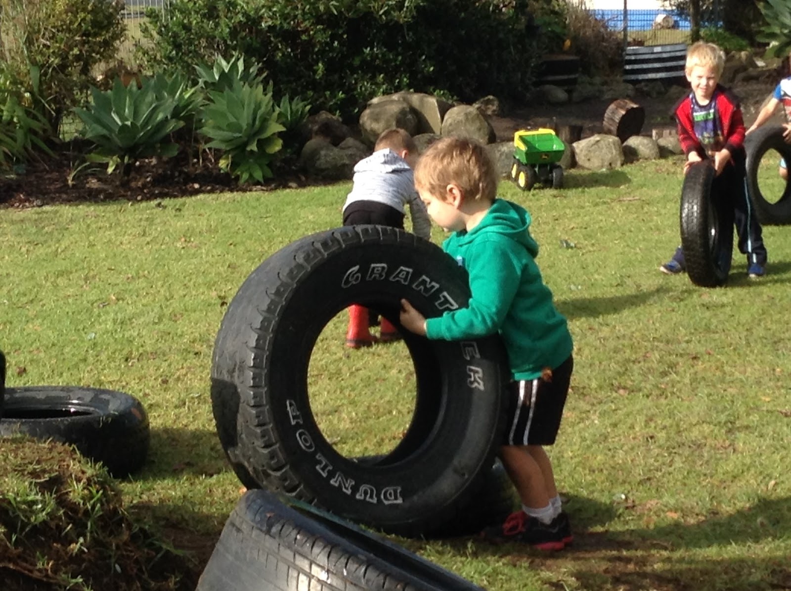 Bream Bay Kindergarten Playing with tyres.