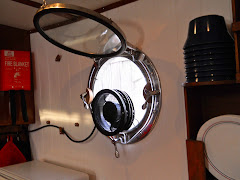 Fred's latest! A new galley porthole exhaust fan! Storage bracket to the left. VERY happy we are!