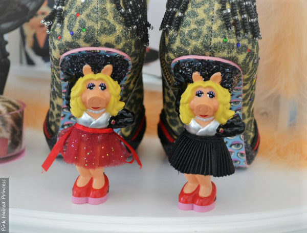 Irregular Choice Disney Muppets Fierce Piggy boots one wearing black skirt one in red Miss Piggy character heels with red glitter skirt and with black pleated skirt