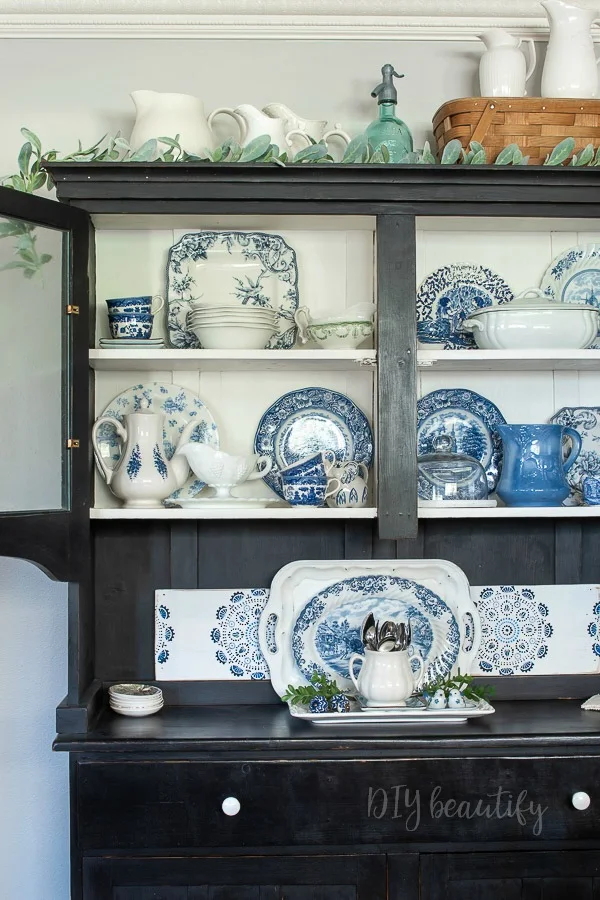 blue and white dishes in hutch