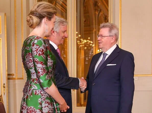 Queen Mathilde wore a green floral-print satin dress by Natan. Édouard, baron Vermeulen is a Belgian fashion designer. Natan red suede pumps