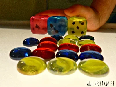 DIY jumbo dice and glass stones on the light table from And Next Comes L