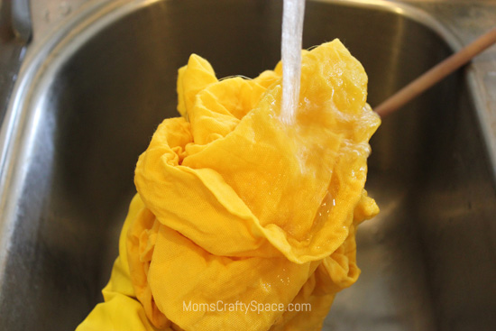 rinsing yellow dyed shirts 