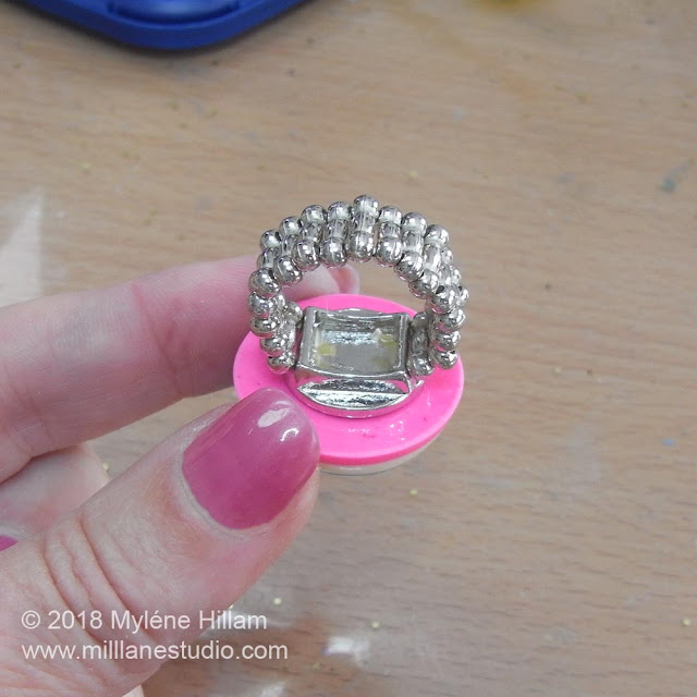 Centring the ring pad blank on the back of the resin cabochon.