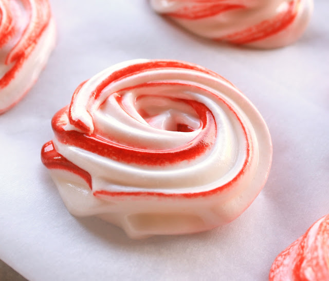 Peppermint Meringue Cookies from LilaLoa inkatrinaskitchen.com #BringtheCOOKIES Red and white striped Peppermint Meringue Cookies on a baking sheet before being baked