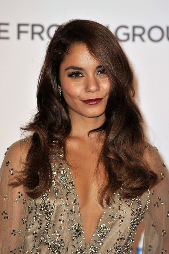 Vanessa Hudgens opted for a vampy lip colour, thick eyelashes, and soft wavy hair.