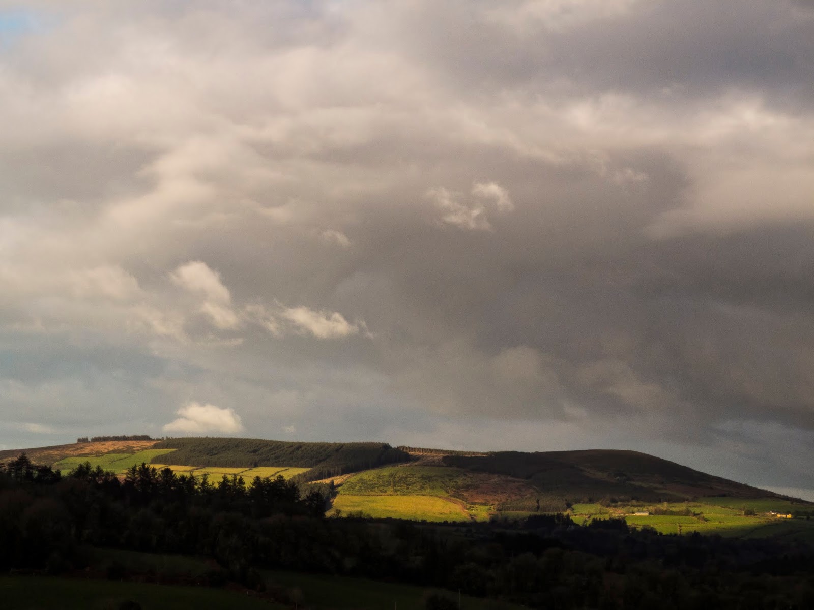 Sunlight Sun shining on the top of a mountain in North Cork.