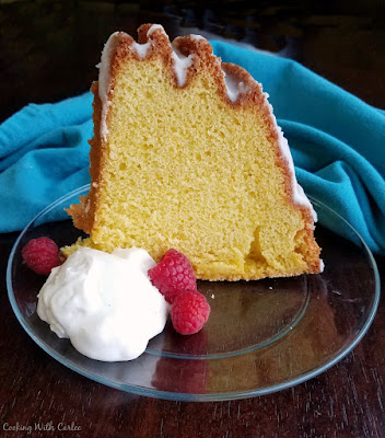A delicious cake that is made not with butter, but egg yolks! It is a light and simple to make cake and a great way to use yolks left from meringues or angel food cakes. slice of cake standing on glass plate with pile of whipped cream and berries nearby