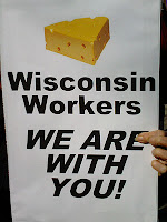 sign with image of cheese saying, Wisconsin workers, we are with you.