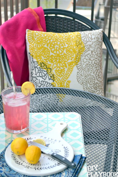 These cute yellow, white and gray throw pillows are from Home Goods and I think they really liven up the balcony! Home goods has great summer balcony decor. 