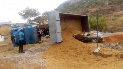 See How a Trailer Load of Sand Cut a Fine Car Into Two in Abuja Car Crash (Photos)