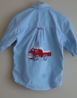 The back of the shirt has an embellished red dump truck
