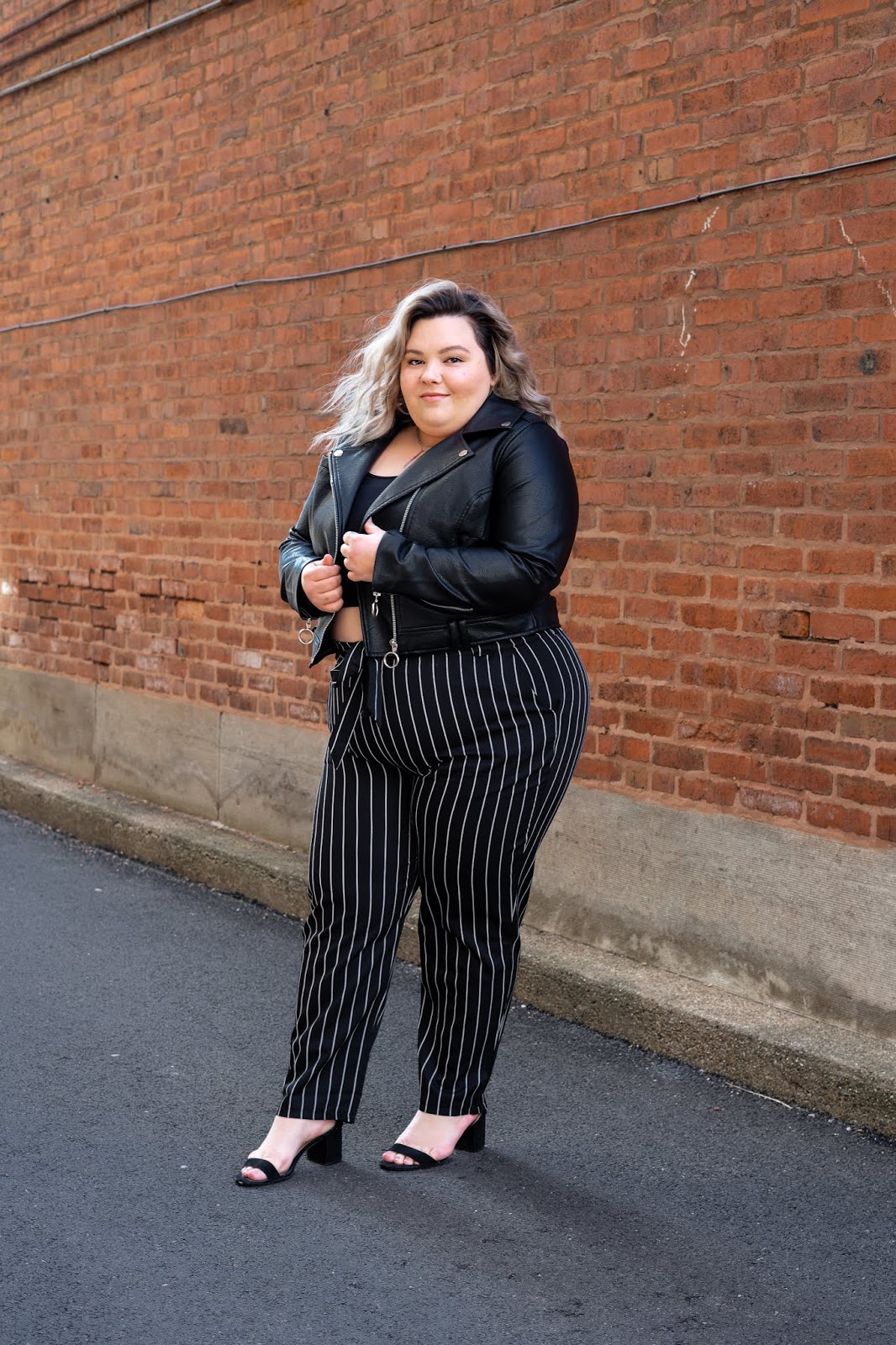 Chicago Plus Size Petite Fashion Blogger, YouTuber, and model Natalie Craig, of Natalie in the City, reviews Fashion Nova's paper bag waist pants and cropped tops.