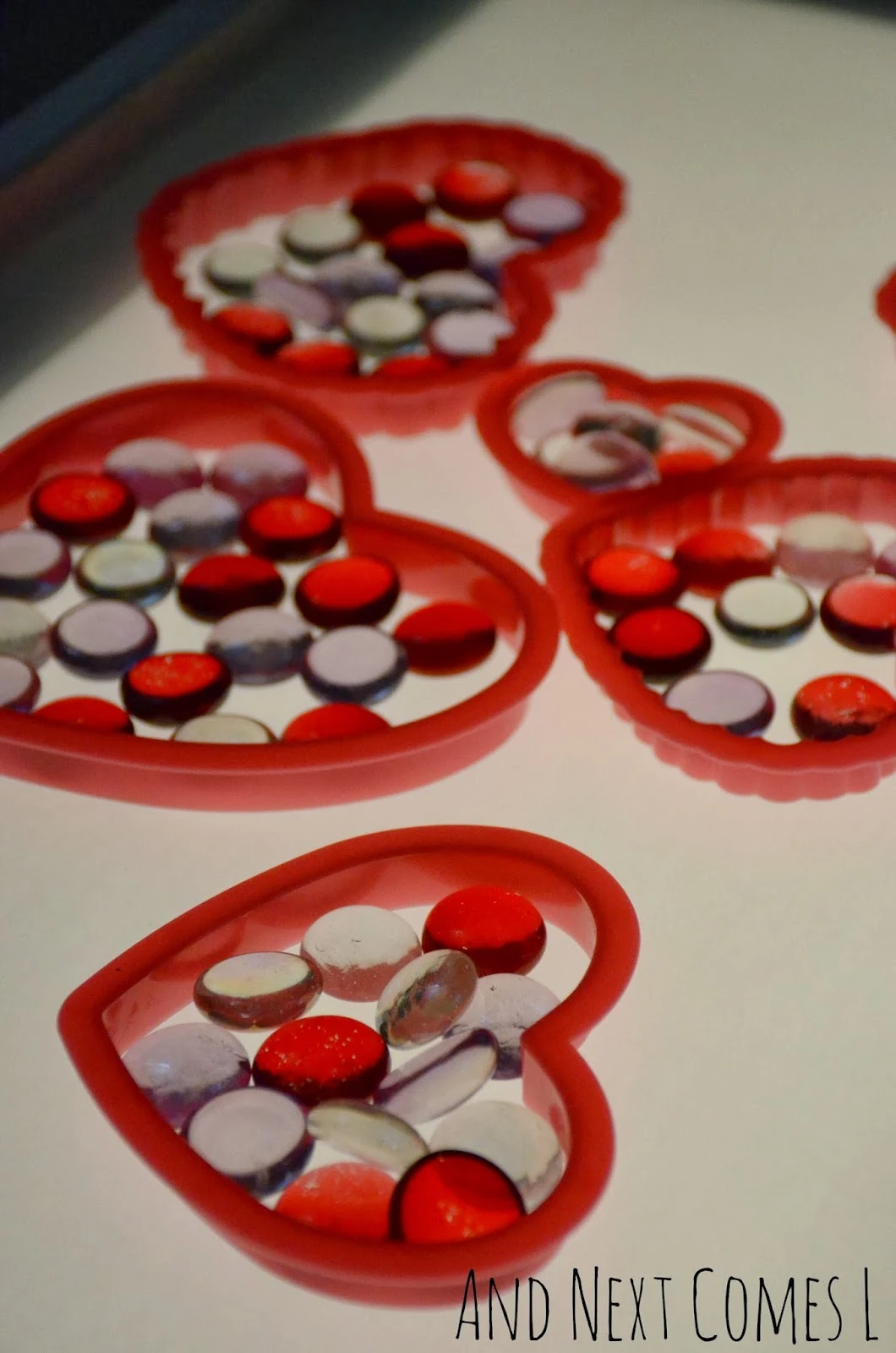 Close up of hearts and glass stones on the light table - perfect for Valentine's Day from And Next Comes L