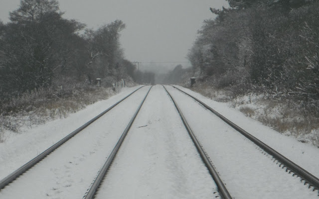 Converging railway lines in snow